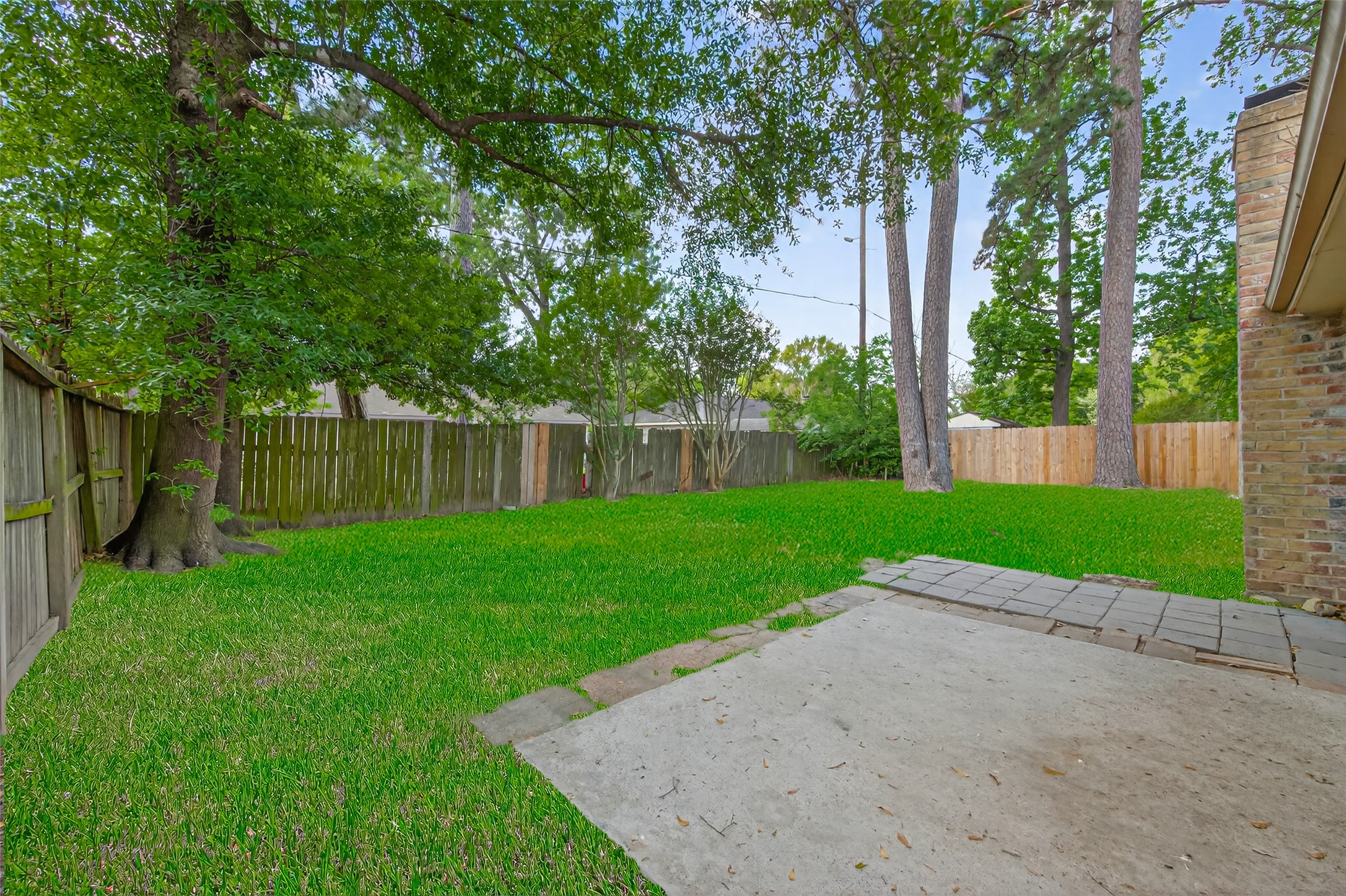 23919 Farm Hill Drive Spring, TX 77373 - Photo 39 of 41 a view of a yard with palm tree and wooden fence