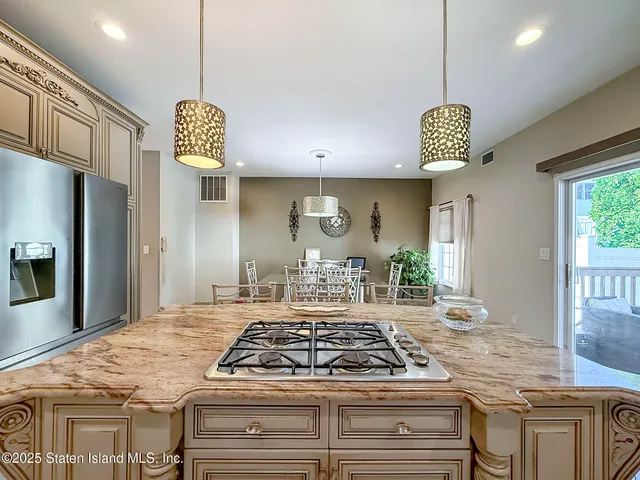 a kitchen with a stove and a chandelier