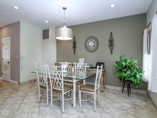 a view of a dining room and kitchen with furniture and a clock