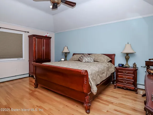 a bedroom with a bed dresser and a window