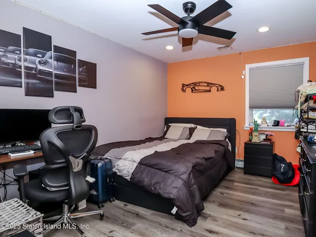 a bedroom with bed and a chandelier