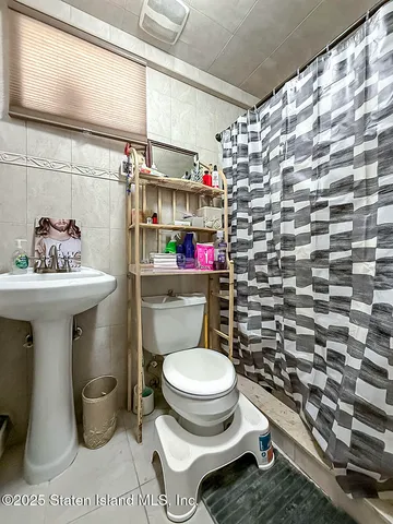 a bathroom with a sink toilet and a shower