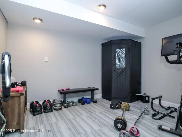 a room with gym equipment and a mirror