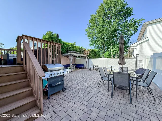 a view of a patio with a table and chairs