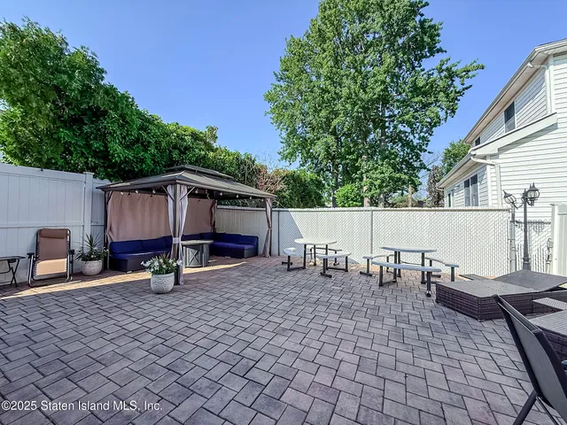 a view of a house with backyard and sitting area