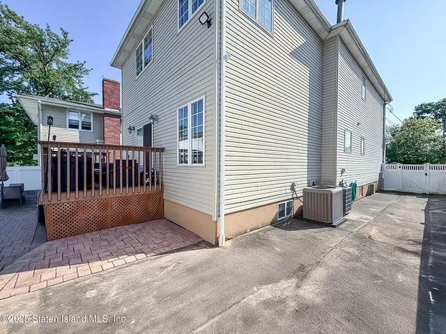 a view of backyard with deck and furniture