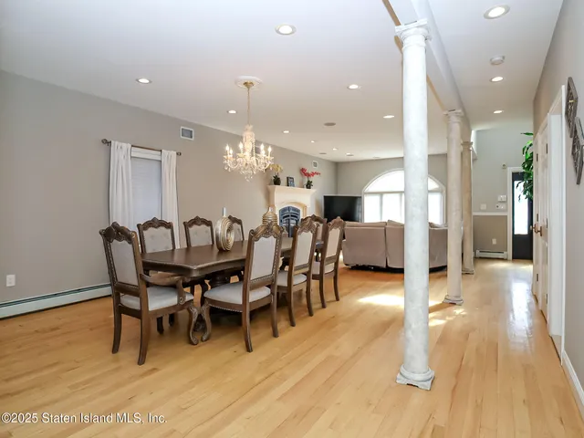 a dining room with furniture and wooden floor