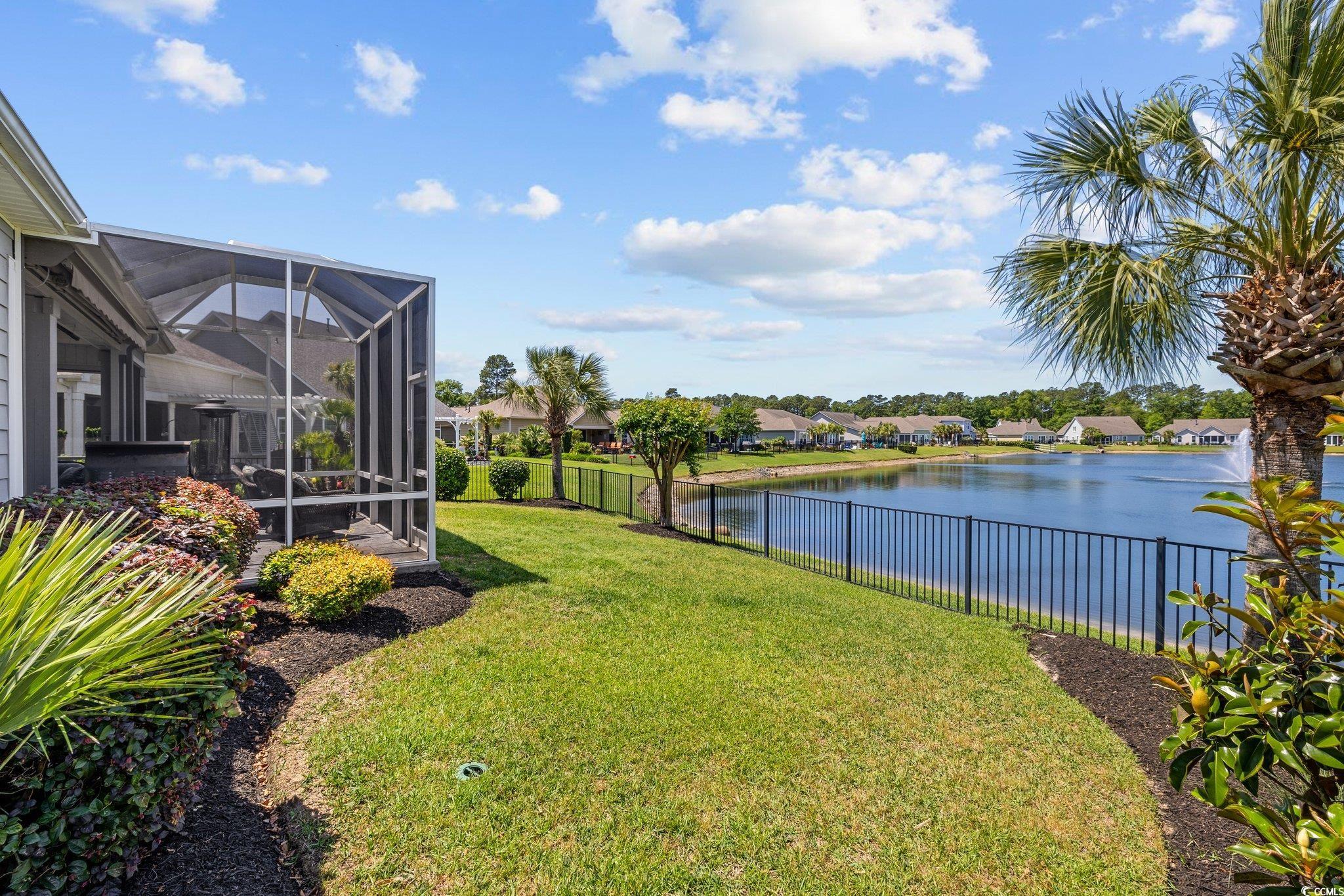 179 Hyacinth Loop Murrells Inlet, SC 29576 - Photo 32 of 40 View of yard with a water view, a lanai, and a fenced backyard