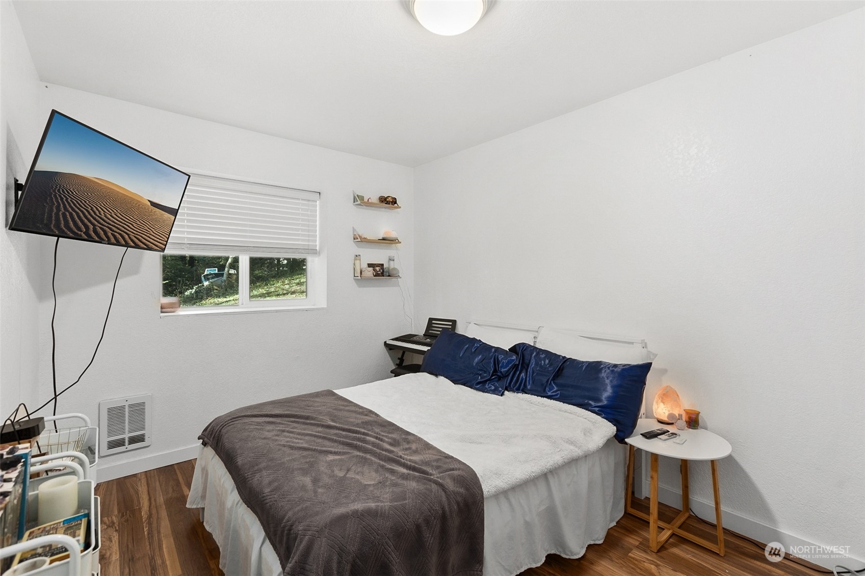 2097 Gull Way Camano Island, WA 98282 - Photo 18 of 35 a bedroom with a bed and wooden floor