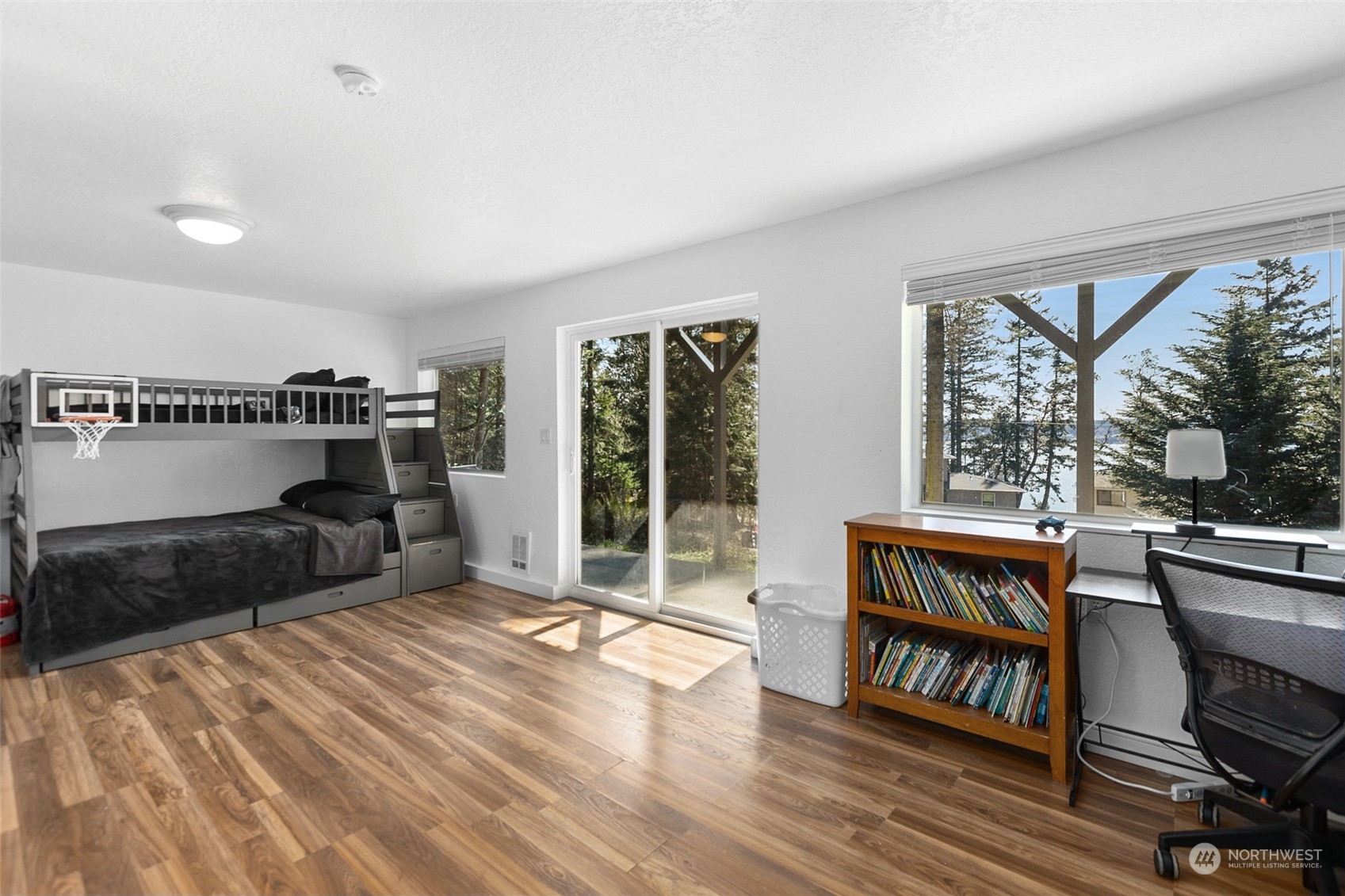 2097 Gull Way Camano Island, WA 98282 - Photo 20 of 35 a living room with furniture a flat screen tv and a floor to ceiling window