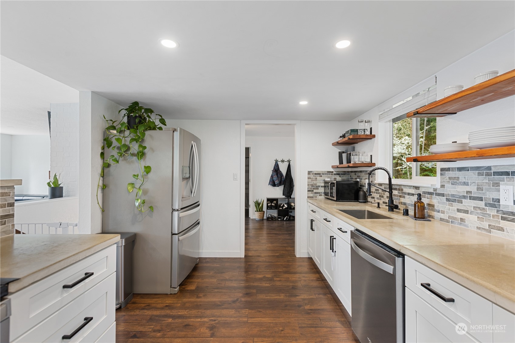 2097 Gull Way Camano Island, WA 98282 - Photo 6 of 35 a kitchen with white cabinets and appliances
