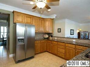 1848 2nd Baxter Crossing Fort Mill, SC 29708 - Photo 4 of 8 a kitchen with stainless steel appliances granite countertop a refrigerator and a sink