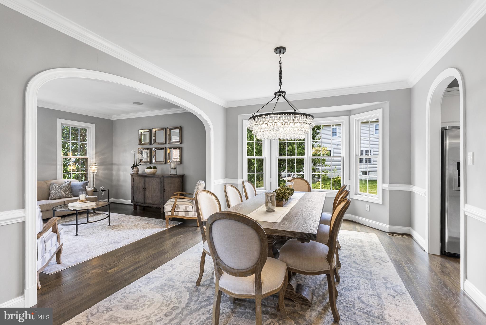 10205 Deep Skies Drive Laurel, MD 20723 - Photo 11 of 40 a dining room with furniture a chandelier and wooden floor