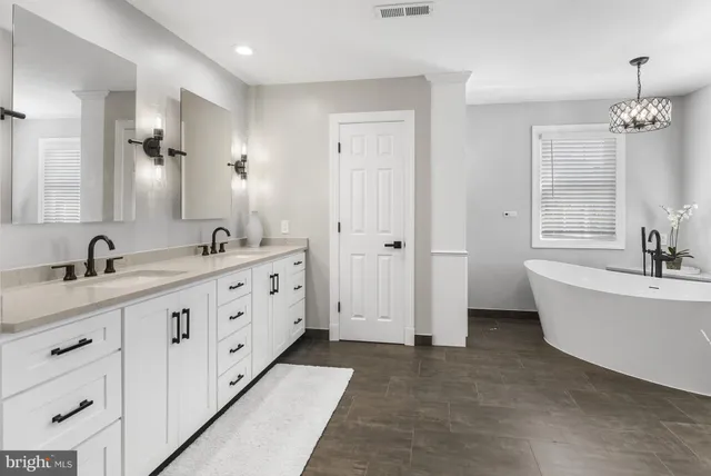 a very nice looking room with a large window and a chandelier