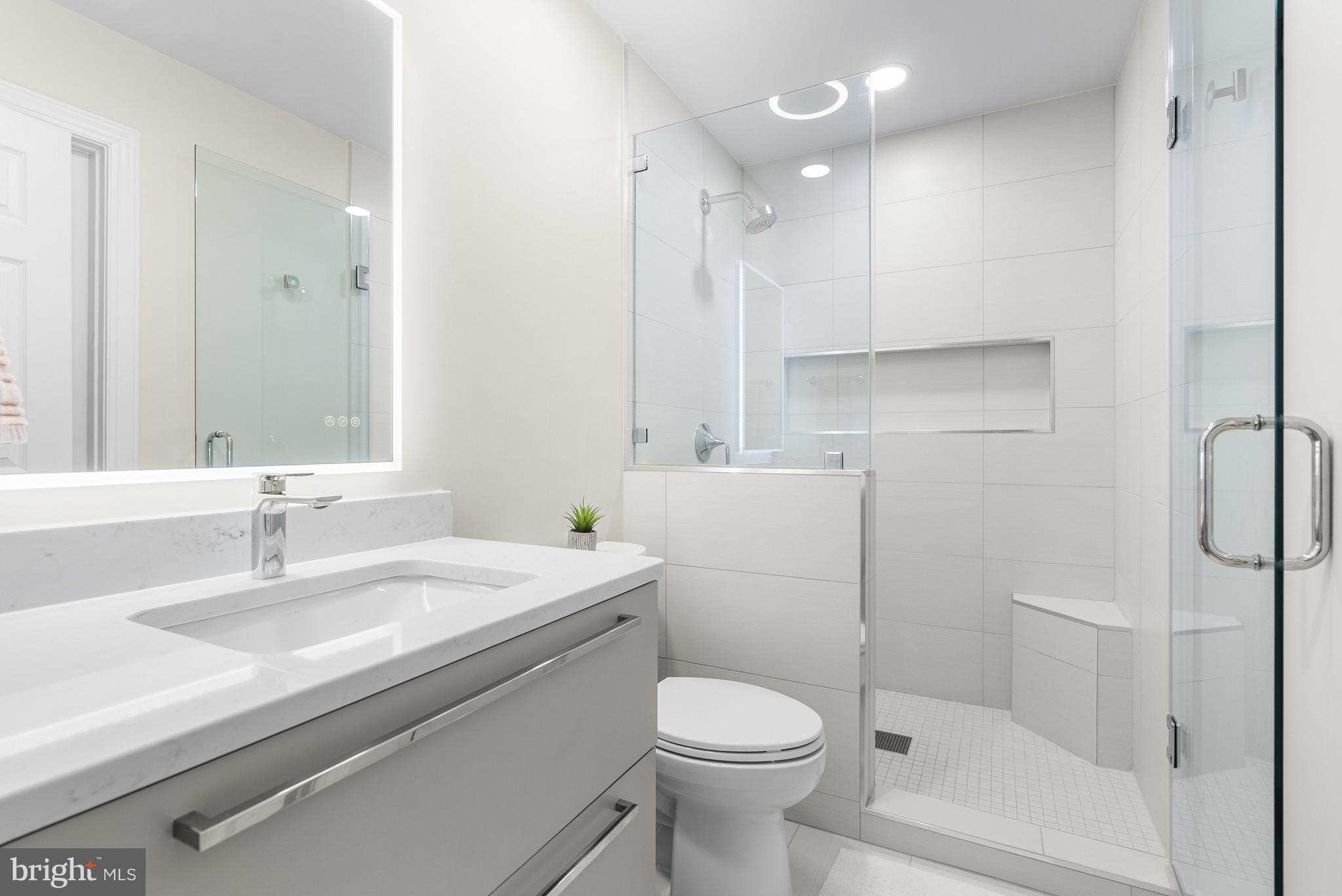 10205 Deep Skies Drive Laurel, MD 20723 - Photo 19 of 40 a bathroom with a sink toilet vanity and shower