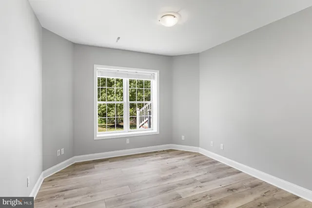 a view of a livingroom with wooden floor and staircase