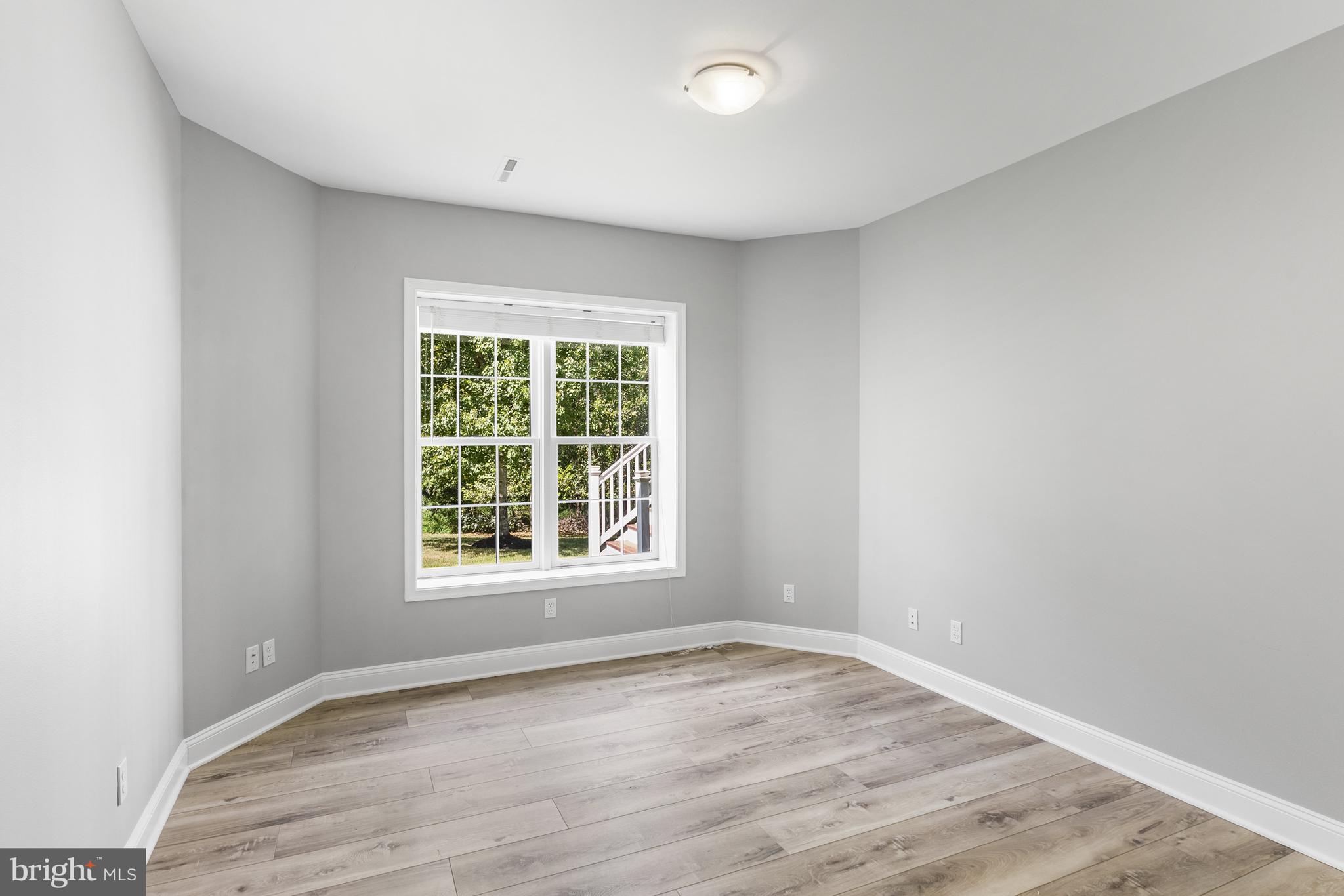 10205 Deep Skies Drive Laurel, MD 20723 - Photo 25 of 40 an empty room with wooden floor and windows