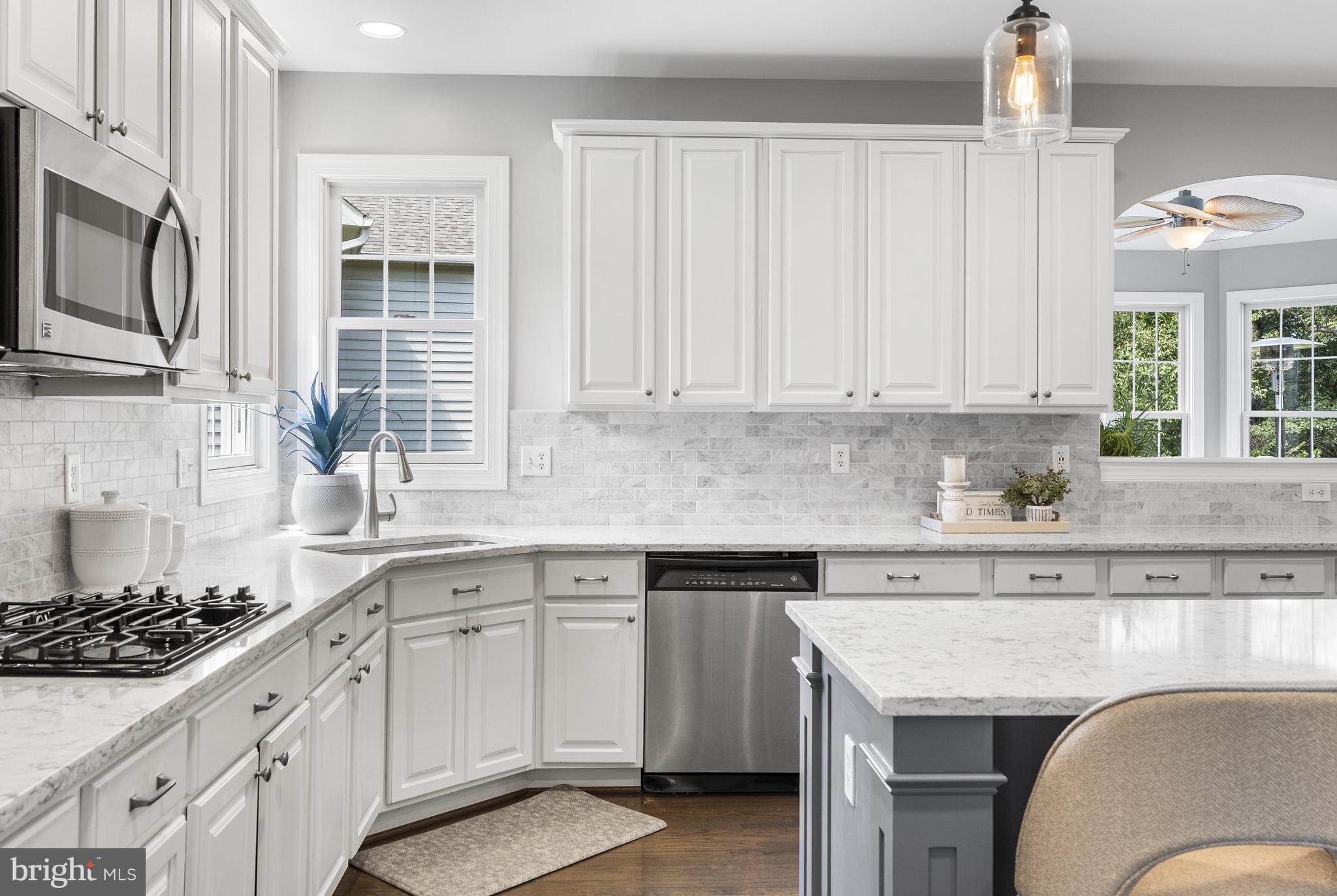 10205 Deep Skies Drive Laurel, MD 20723 - Photo 5 of 40 a kitchen with stainless steel appliances granite countertop a stove a sink and a microwave