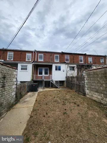 a view of a house with wooden fence
