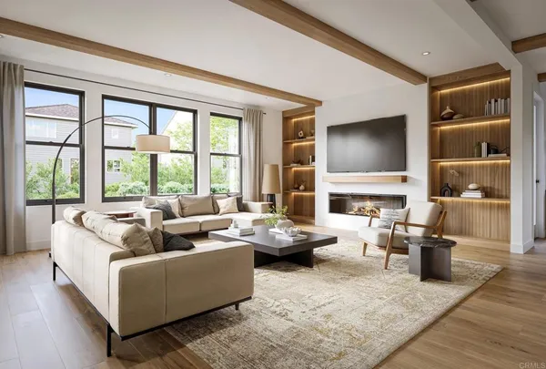 a living room with fireplace furniture and a large window