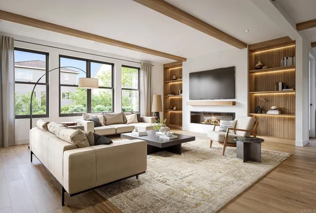 a living room with fireplace furniture and a large window