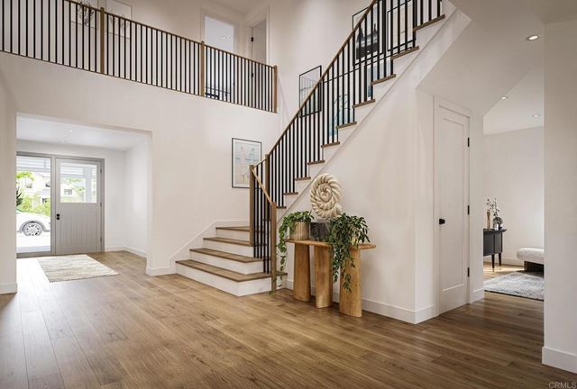 a view of entryway and hall with wooden floor