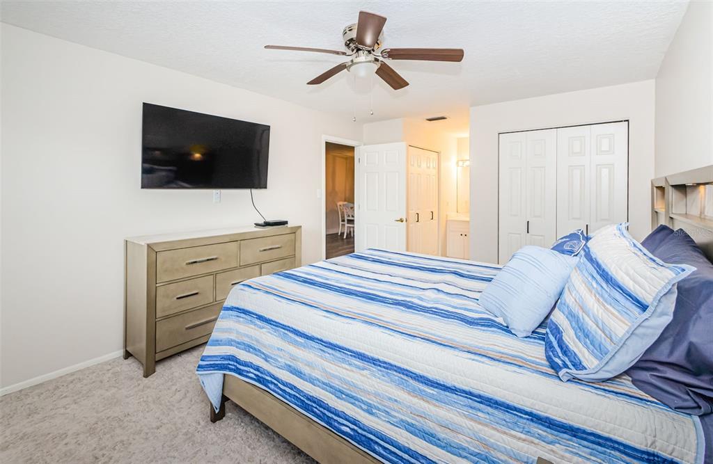 3716 Trophy Boulevard, Unit 3716 New Port Richey, FL 34655 - Photo 12 of 56 a bedroom with a bed and a flat screen tv