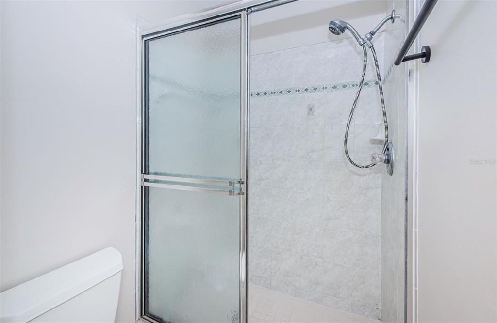 3716 Trophy Boulevard, Unit 3716 New Port Richey, FL 34655 - Photo 14 of 56 a bathroom with a glass shower door