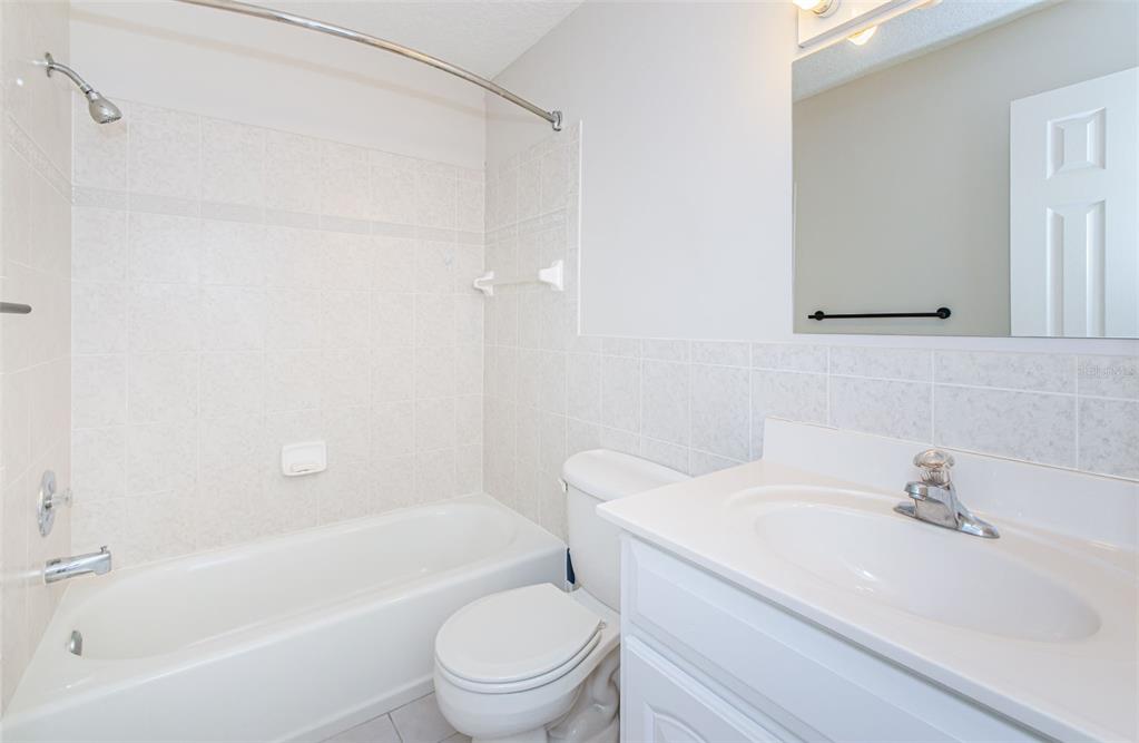 3716 Trophy Boulevard, Unit 3716 New Port Richey, FL 34655 - Photo 15 of 56 a bathroom with a sink toilet and shower