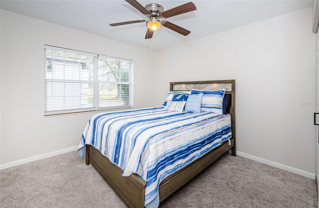 3716 Trophy Boulevard, Unit 3716 New Port Richey, FL 34655 - Photo 16 of 56 a bedroom with a bed and window