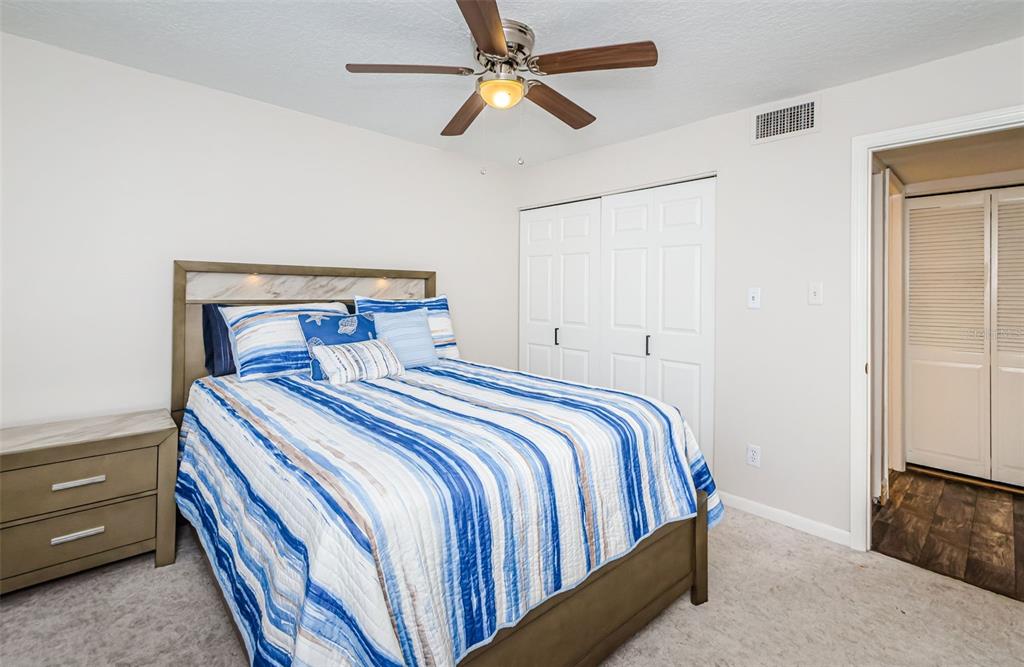 3716 Trophy Boulevard, Unit 3716 New Port Richey, FL 34655 - Photo 17 of 56 a bedroom with a bed and a chandelier