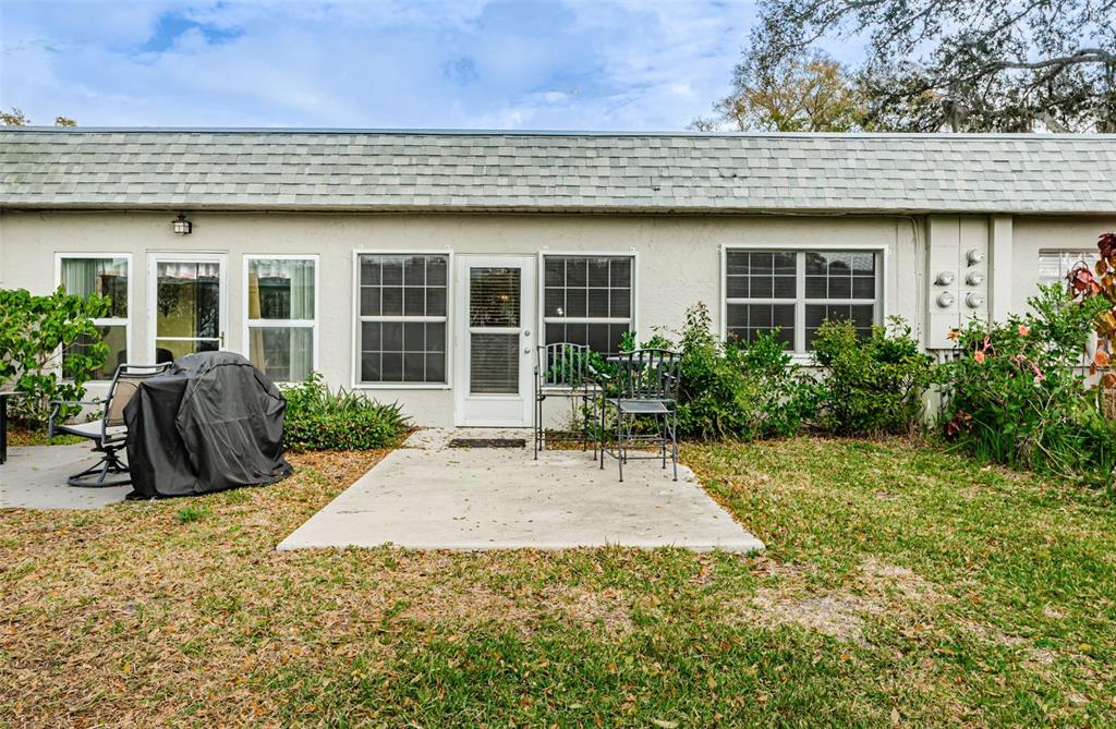 3716 Trophy Boulevard, Unit 3716 New Port Richey, FL 34655 - Photo 18 of 56 a view of a house with backyard sitting area and garden
