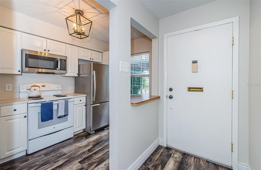 3716 Trophy Boulevard, Unit 3716 New Port Richey, FL 34655 - Photo 3 of 56 a kitchen with stainless steel appliances a refrigerator stove and microwave