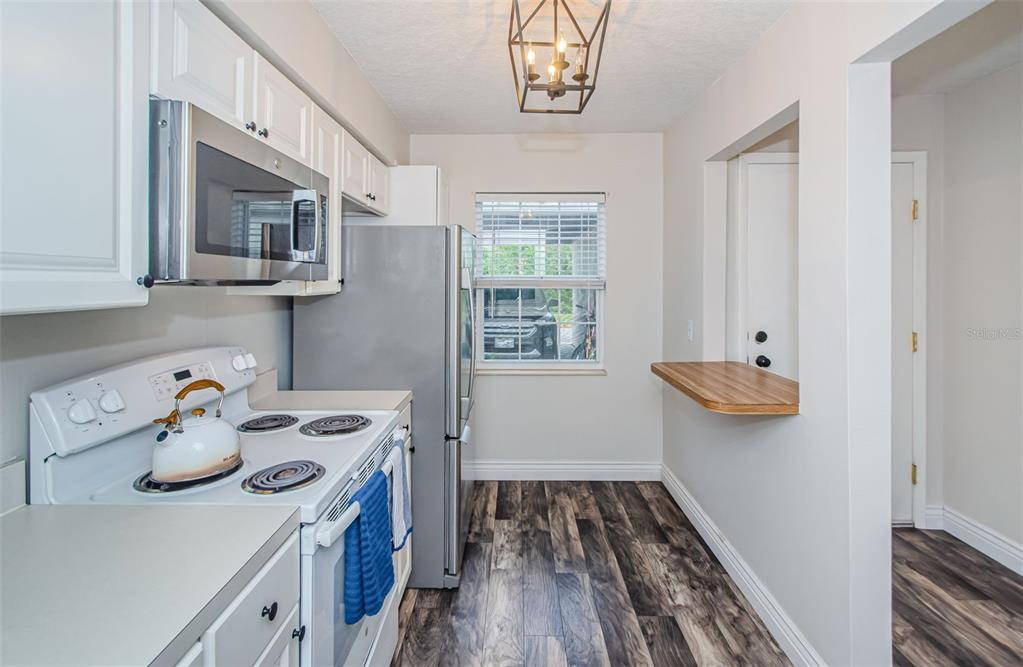 3716 Trophy Boulevard, Unit 3716 New Port Richey, FL 34655 - Photo 5 of 56 a kitchen with a refrigerator and a stove top oven