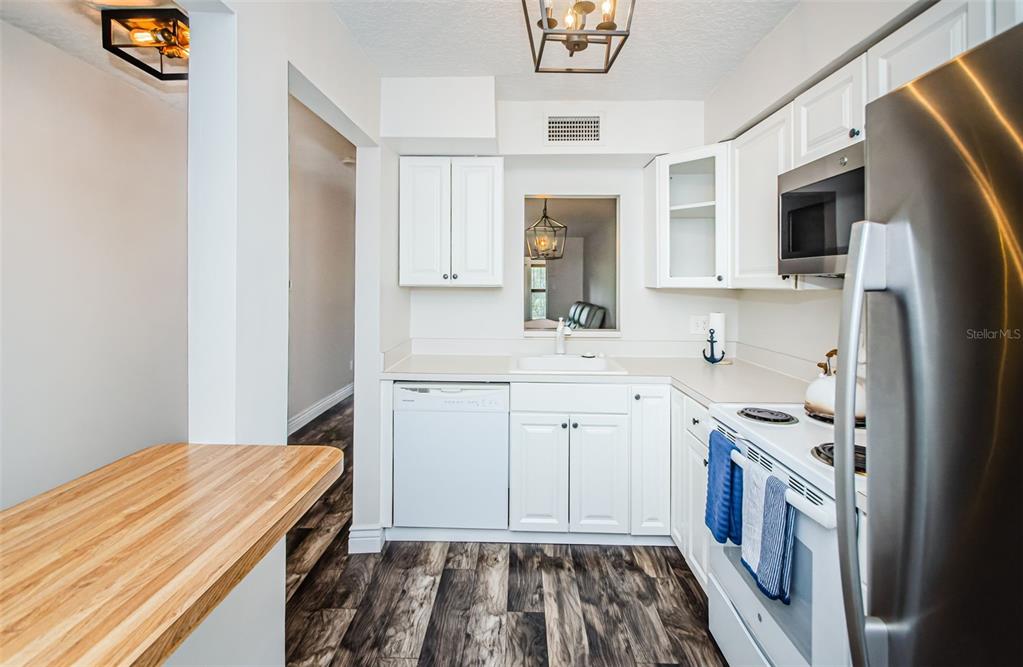 3716 Trophy Boulevard, Unit 3716 New Port Richey, FL 34655 - Photo 6 of 56 a kitchen with a sink stove and refrigerator