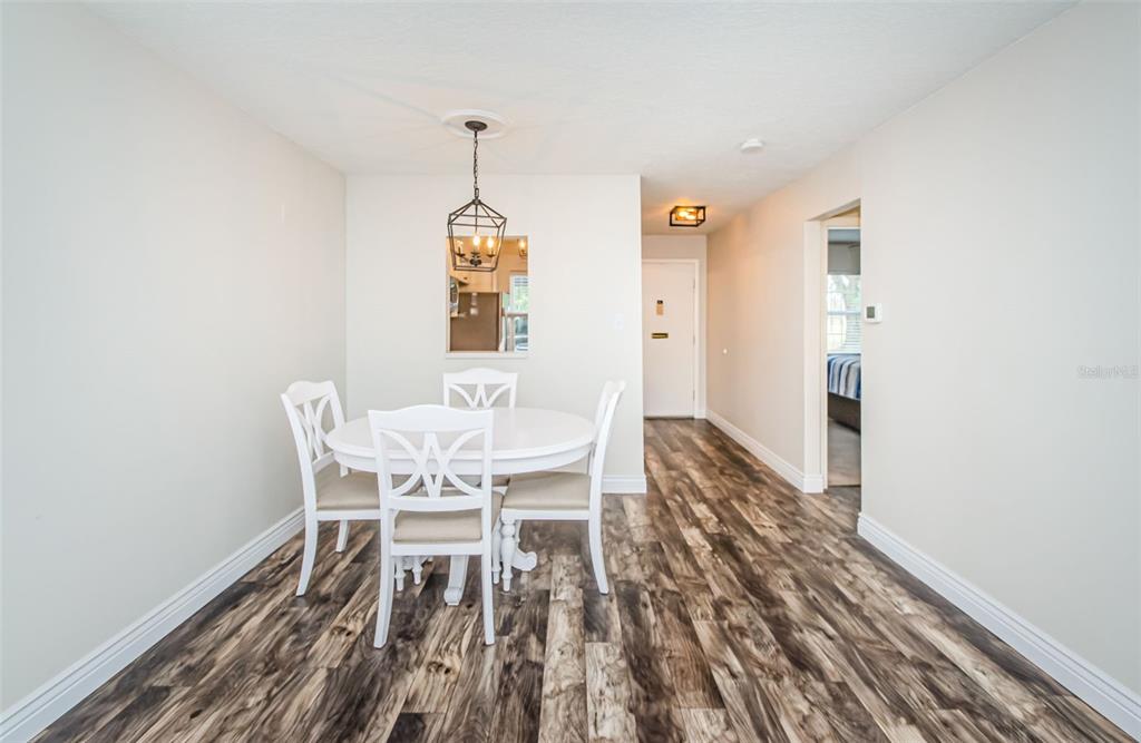 3716 Trophy Boulevard, Unit 3716 New Port Richey, FL 34655 - Photo 7 of 56 a view of a dining room with furniture and wooden floor