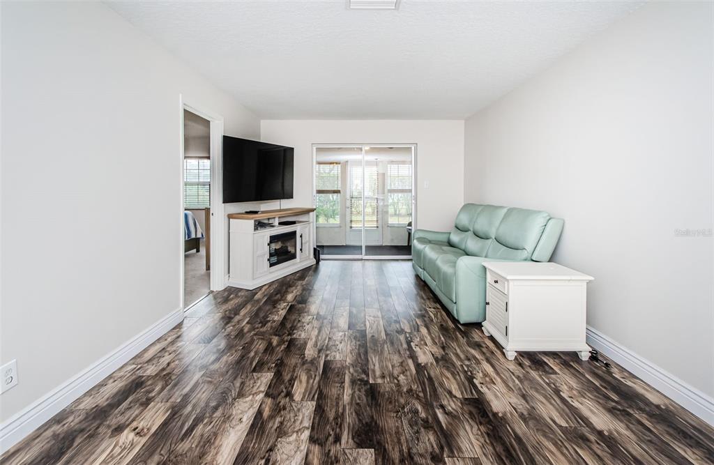 3716 Trophy Boulevard, Unit 3716 New Port Richey, FL 34655 - Photo 8 of 56 a living room with furniture and a flat screen tv