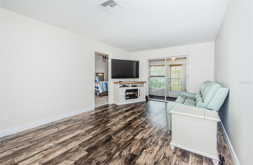 3716 Trophy Boulevard, Unit 3716 New Port Richey, FL 34655 - Photo 9 of 56 a living room with furniture and a flat screen tv