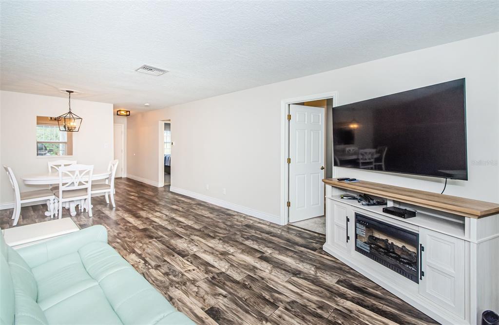 3716 Trophy Boulevard, Unit 3716 New Port Richey, FL 34655 - Photo 10 of 56 a living room with furniture and a flat screen tv