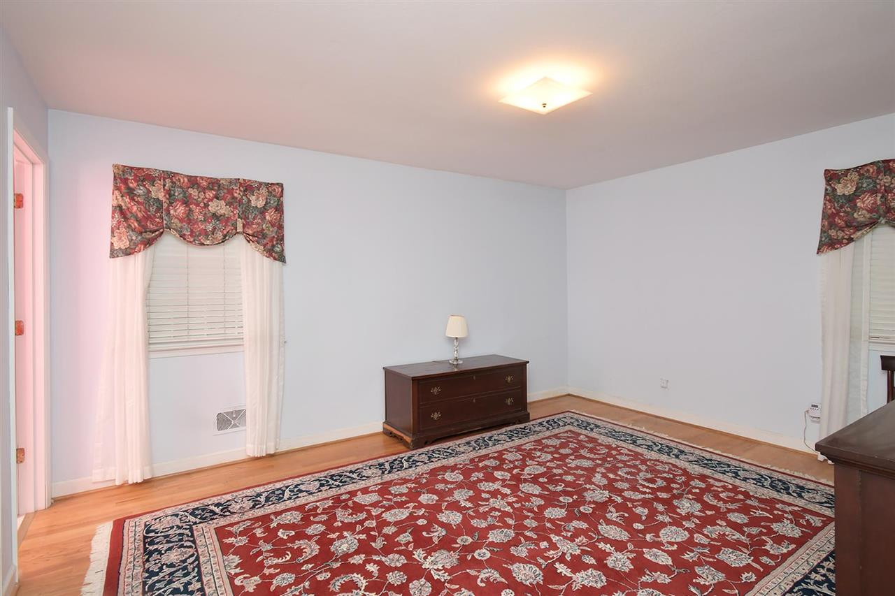 505 South Hollybrook Road Wendell, NC 27591 - Photo 16 of 24 Master Bedroom is located on the back side of the house. Generous space and hardwood floors. Master Bedroom