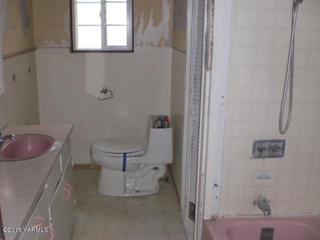 2906 Wiley Road Yakima, WA 98903 - Photo 7 of 27 a bathroom with a toilet sink and mirror