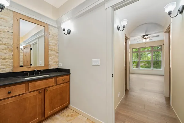 a bathroom with a sink a mirror and a shower