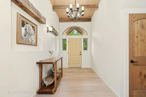 a view of an entryway with wooden floor