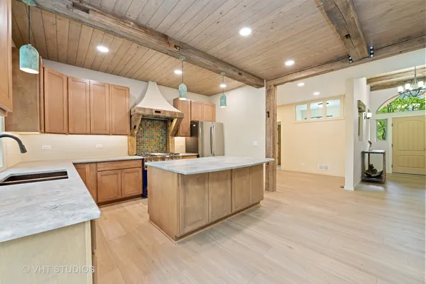 a kitchen with stainless steel appliances granite countertop a sink and cabinets