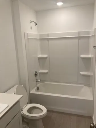 a bathroom with a toilet and a bathtub