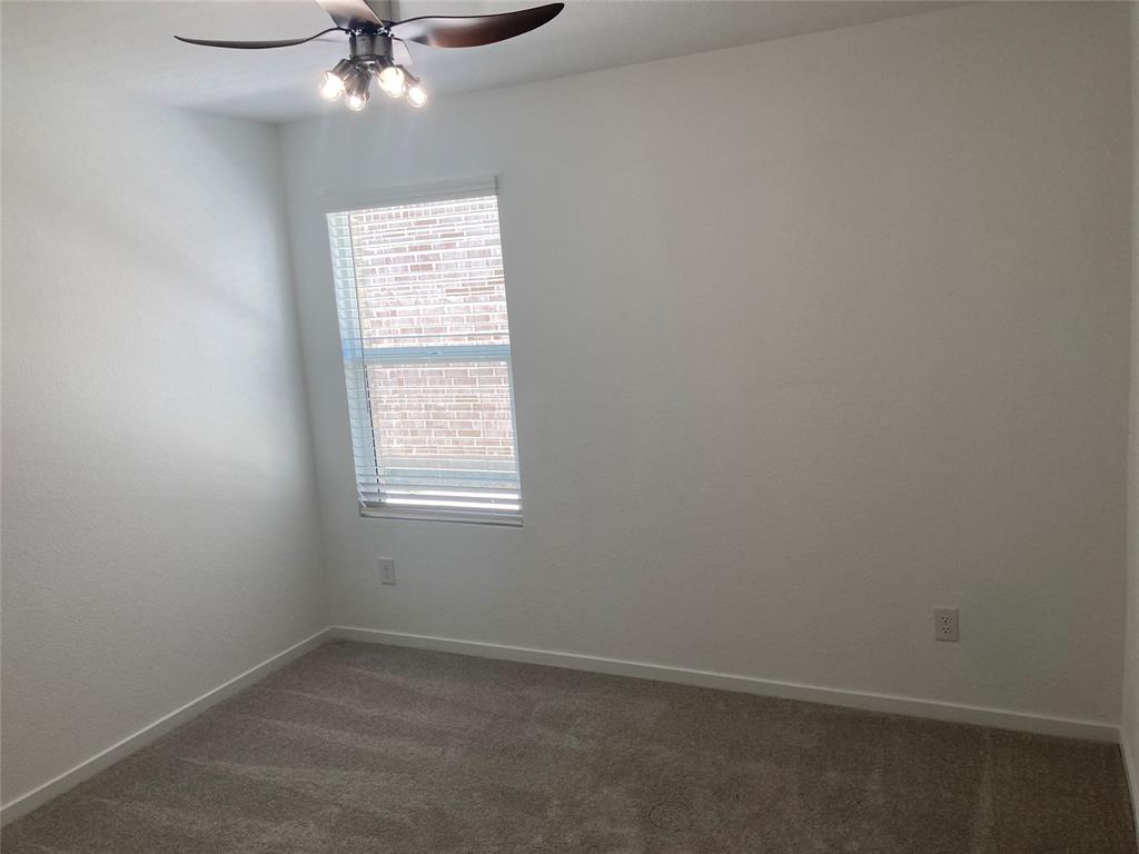 1520 Elliott Road Howe, TX 75459 - Photo 26 of 29 an empty room with a window and a fan