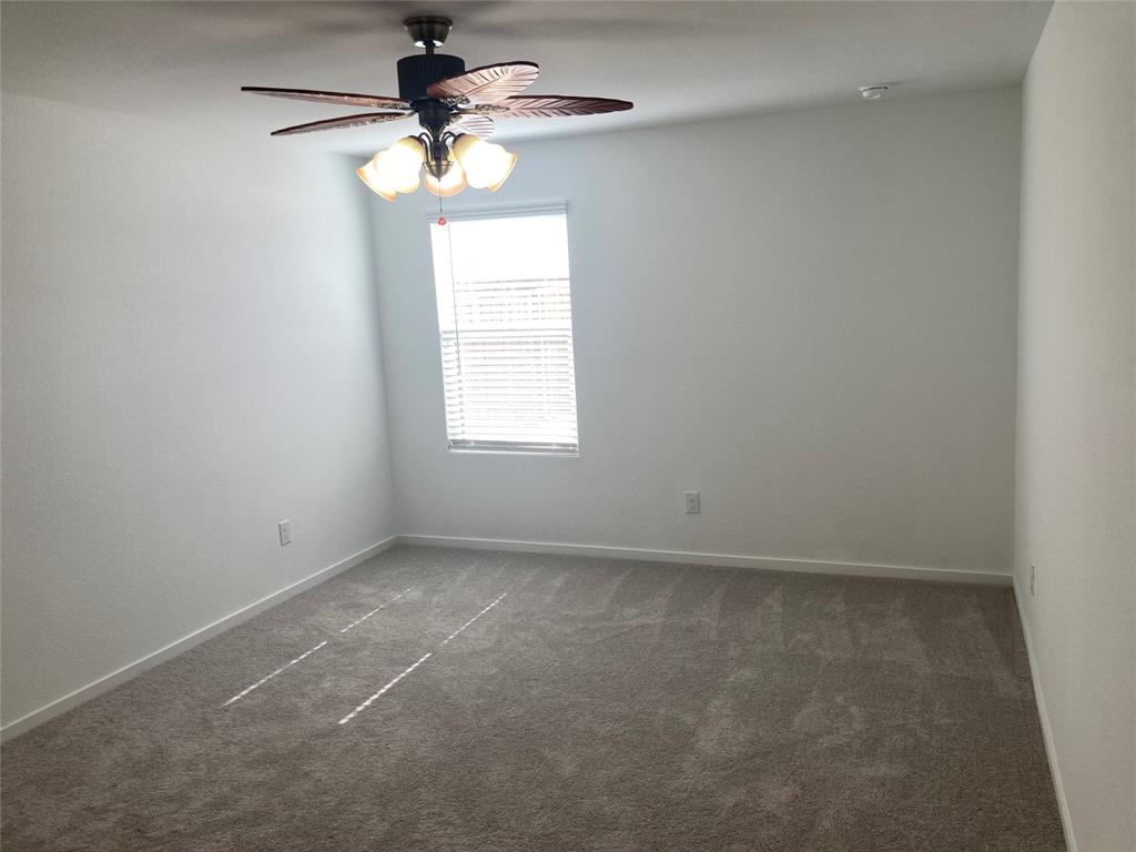 1520 Elliott Road Howe, TX 75459 - Photo 5 of 29 an empty room with a window and a chandelier fan