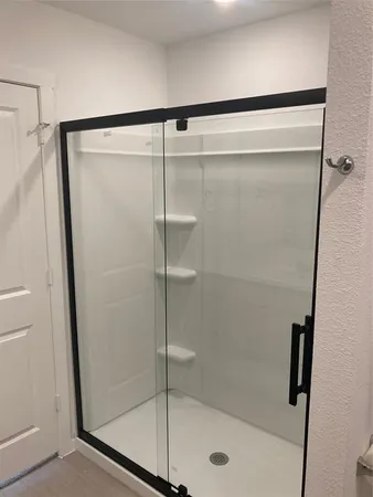 a bathroom with a glass shower door