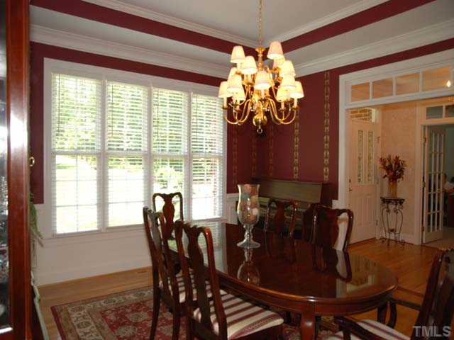 1005 Farnsworth Road Wake Forest, NC 27587 - Photo 4 of 25 The impressive dining room has gorgeous moldings and trey ceilings, a lovely chandelier, beautiful windows offering lots of natural light, and lovely hardwood floors.