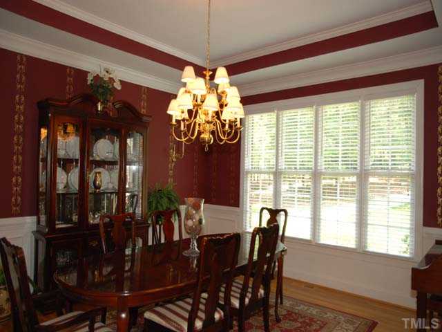 1005 Farnsworth Road Wake Forest, NC 27587 - Photo 5 of 25 The impressive dining room has gorgeous moldings and trey ceilings, a lovely chandelier, beautiful windows offering lots of natural light, and lovely hardwood floors.